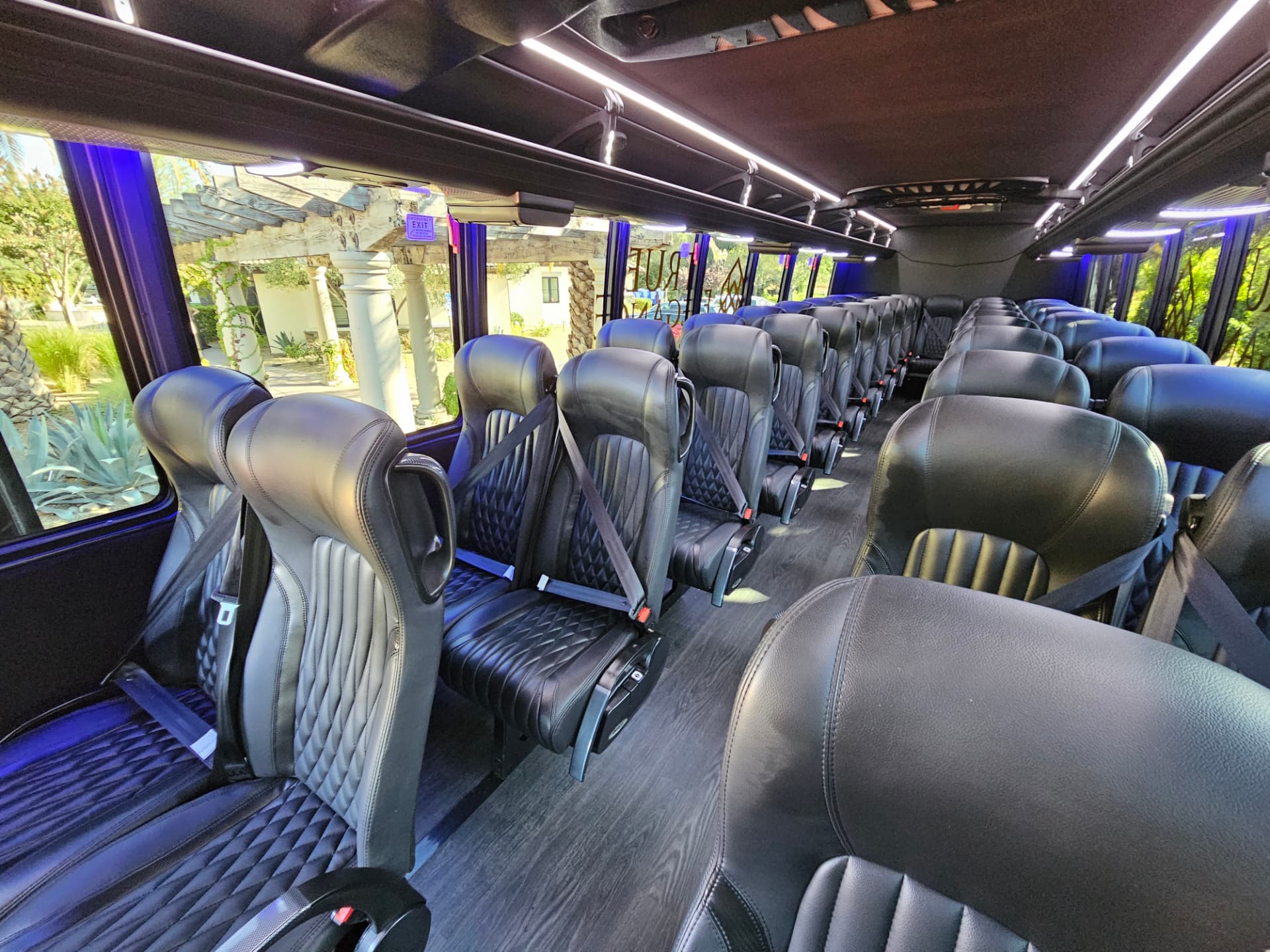 Quilted black leather reclining seats with seatbelts inside a True Elegance commuter shuttle coach for Tri-Valley employee shuttle routes