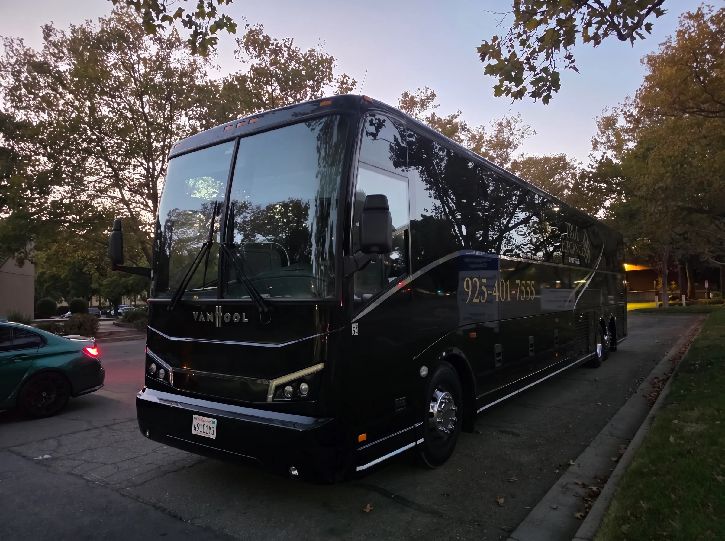 Pebble Beach event motorcoach at dusk Black True Elegance Van Hool charter bus staged at dusk for Pebble Beach event transportation